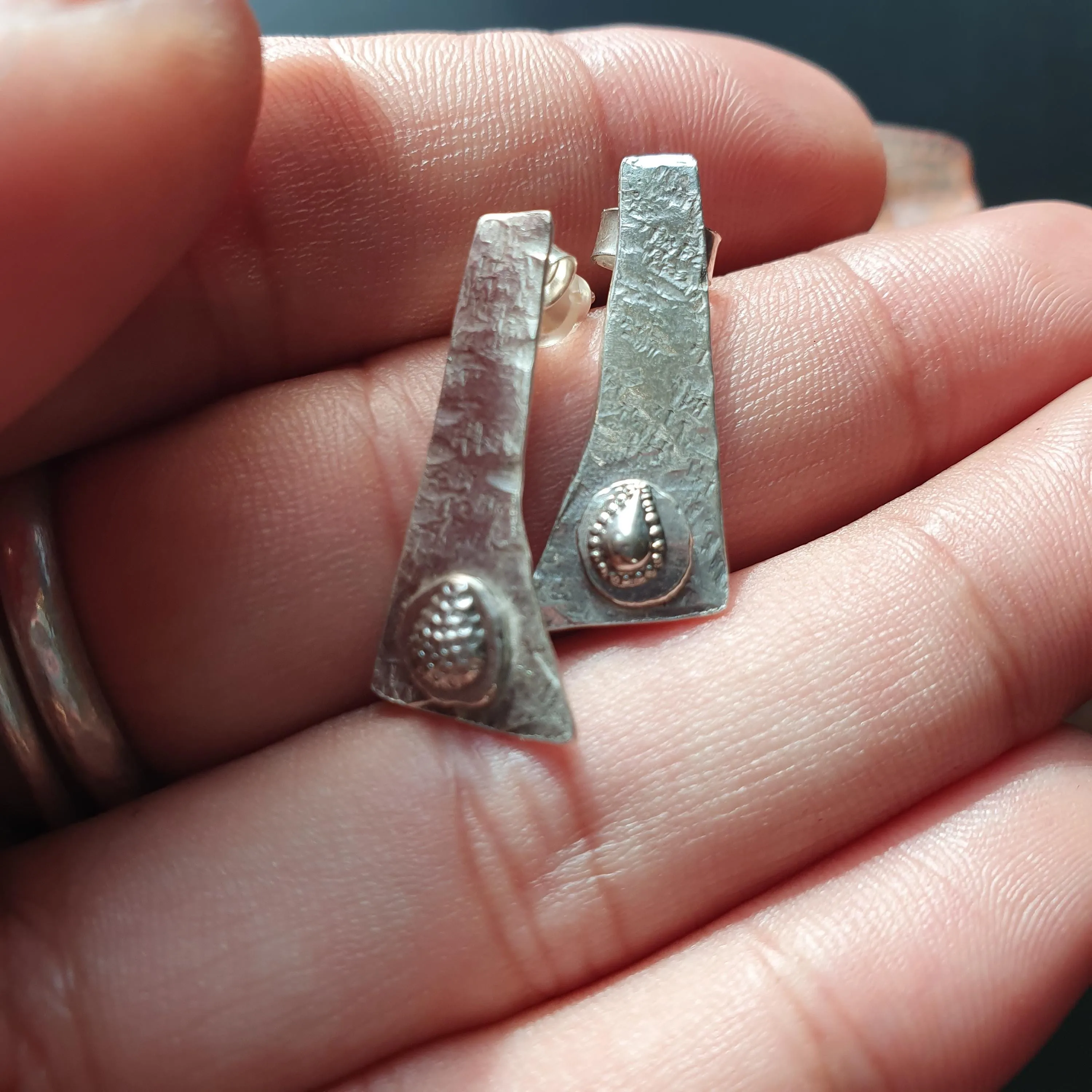 Pair of unique handcrafted earrings, Asymmetrical, textured design, triangular shape,tear drop detail,hammered finish, artisanal,silver, 925