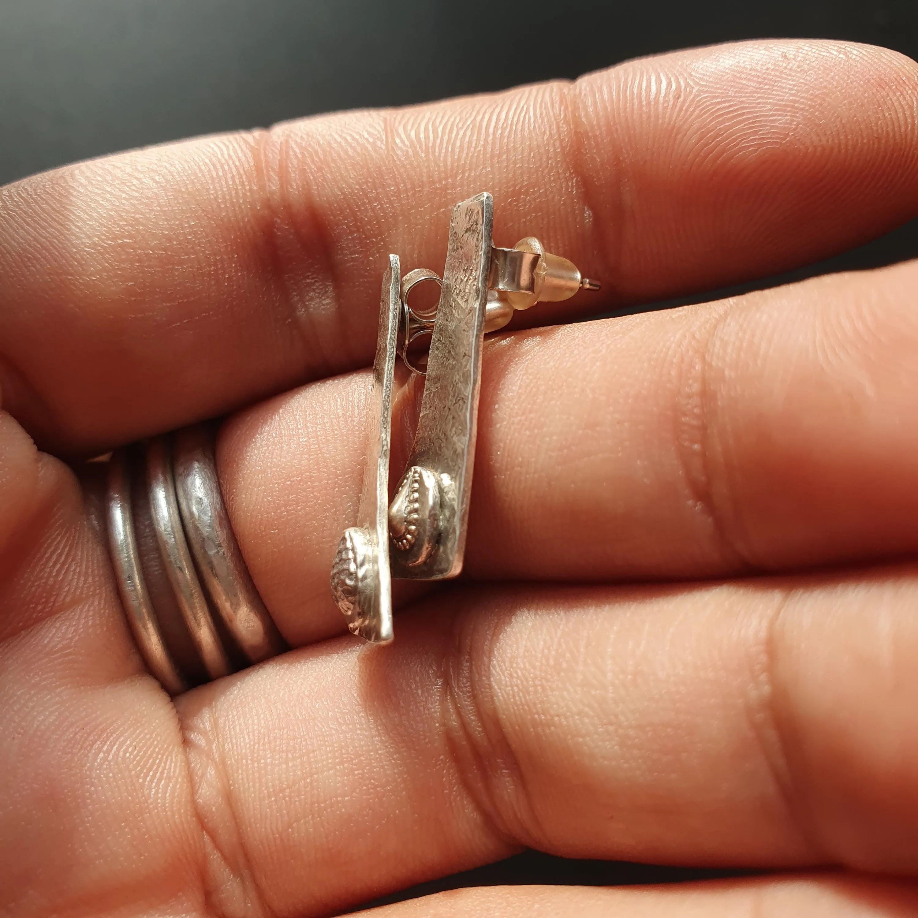 Pair of unique handcrafted earrings, Asymmetrical, textured design, triangular shape,tear drop detail,hammered finish, artisanal,silver, 925