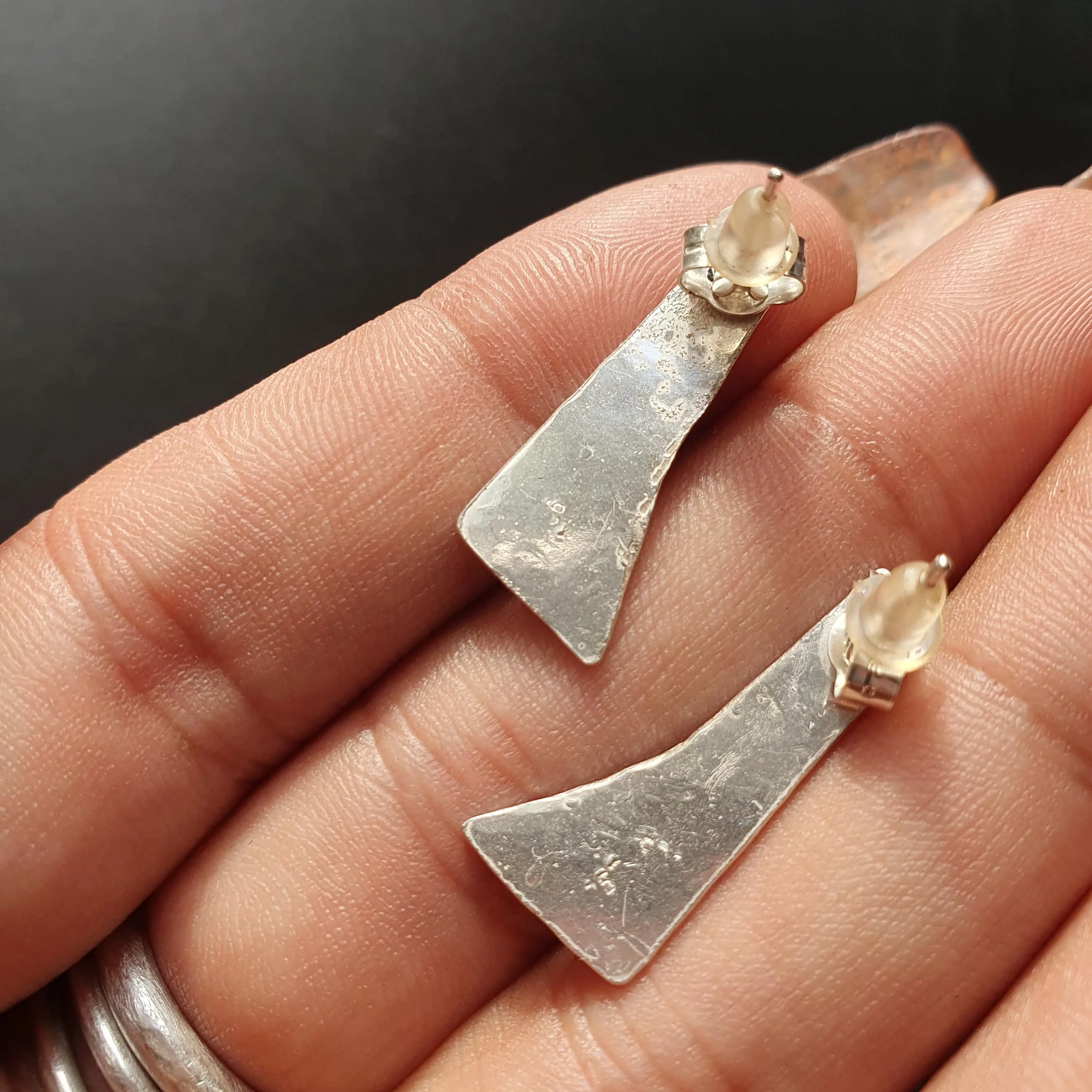Pair of unique handcrafted earrings, Asymmetrical, textured design, triangular shape,tear drop detail,hammered finish, artisanal,silver, 925